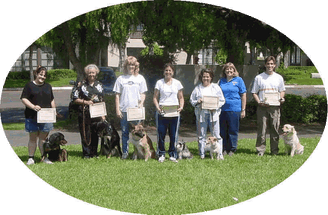Photo of six dog and handler teams with instructor after graduating